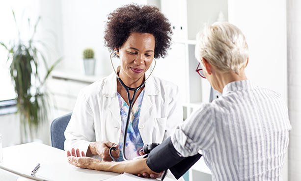 female nurse checking female patient vitals