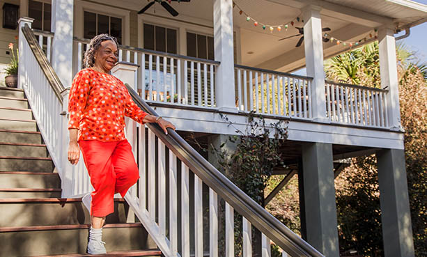 older woman walking down staircase