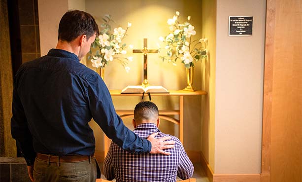 pastor praying with patient