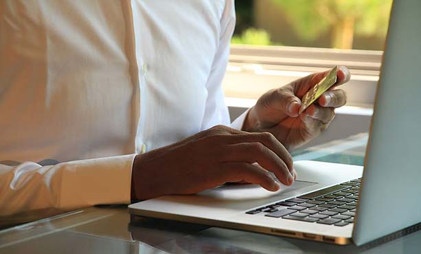 man holding credit card making online payment