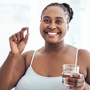 woman holding a pill